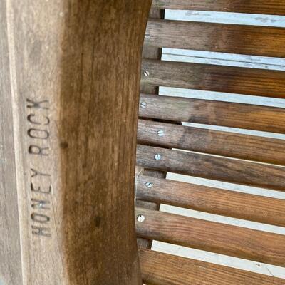 Wooden Honey Rock porch swing with foot rest and cup holders