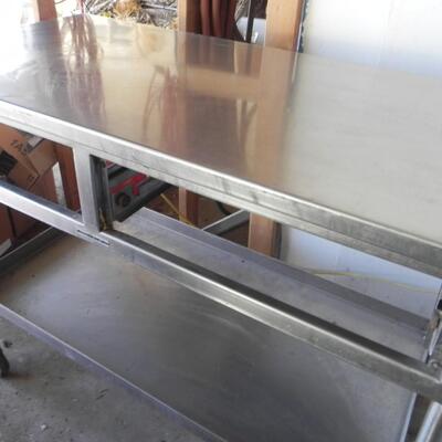 LOT 209  METAL TABLE ON CASTORS AND FURNITURE MOVER