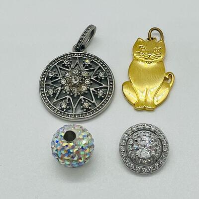 Lot 130: 3 crystal silvertone pendants and a goldtone Kitty