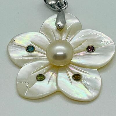 Lot 141: Mother of Pearl Flower with Cultured Pearl Center, Inset Gemstones, & Sterling Bail
