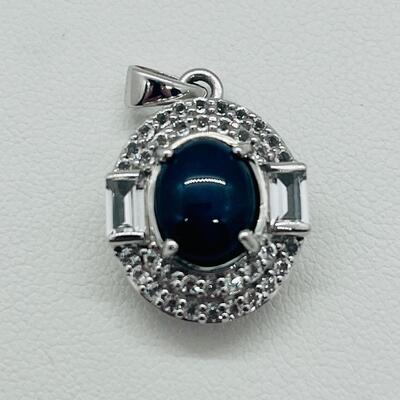 Lot 146: 925 KH Thailand Blue Star Sapphire Oval Pendant Surrounded by Diamonds, Flanked by 2 Diamond Baguettes