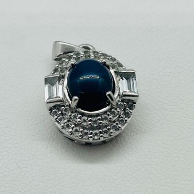 Lot 146: 925 KH Thailand Blue Star Sapphire Oval Pendant Surrounded by Diamonds, Flanked by 2 Diamond Baguettes