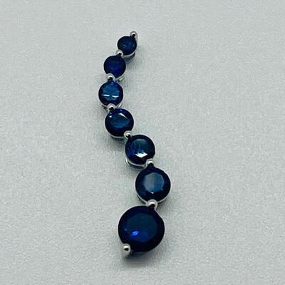 Lot 155: 10k White Gold Blue Sapphire "Journey" Pendant