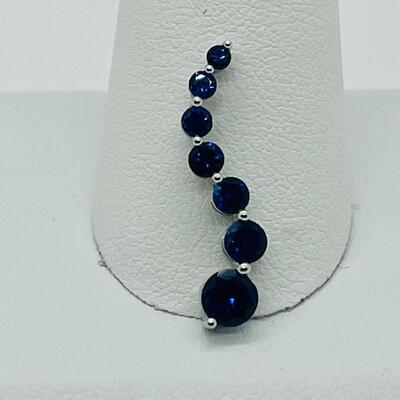 Lot 155: 10k White Gold Blue Sapphire "Journey" Pendant