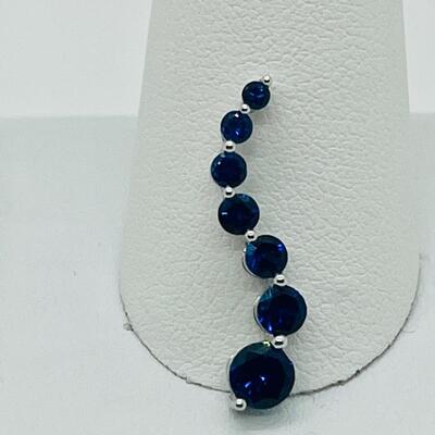 Lot 155: 10k White Gold Blue Sapphire "Journey" Pendant