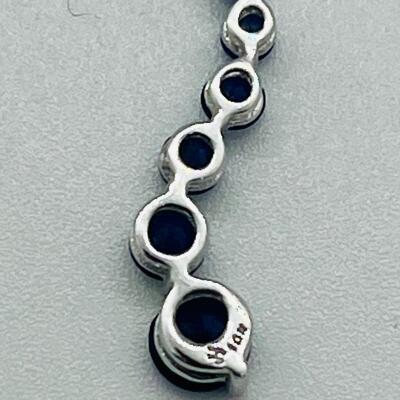 Lot 155: 10k White Gold Blue Sapphire "Journey" Pendant
