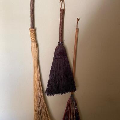 Three decorative vintage brooms