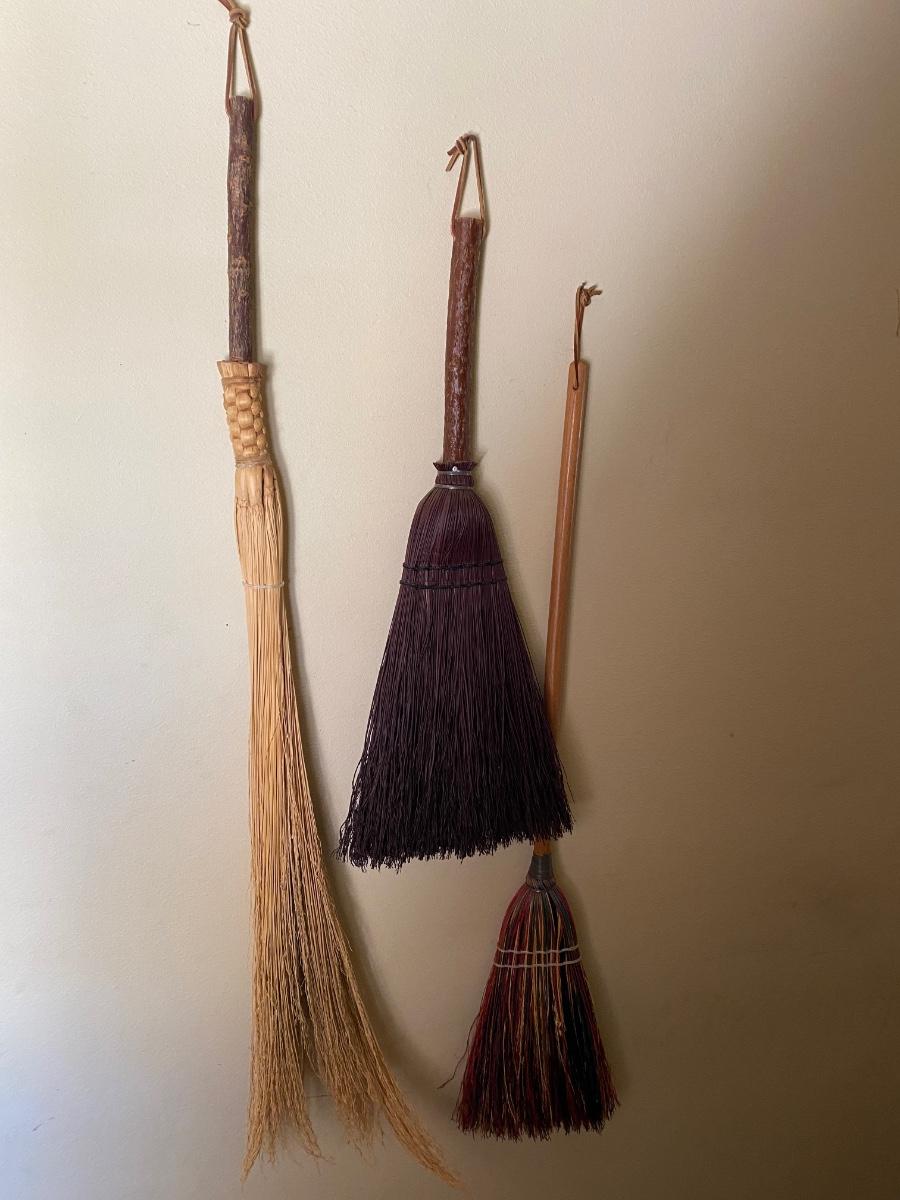 Three decorative vintage brooms