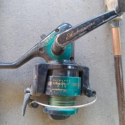 LOT 231  TWO FISHING POLES AND REELS