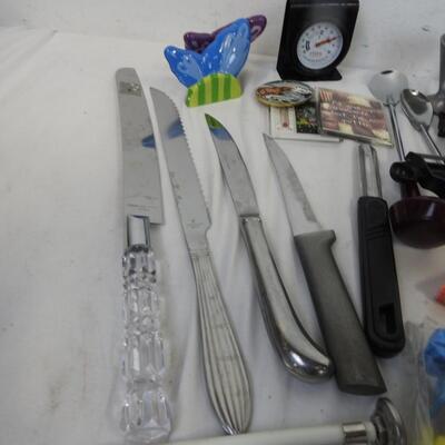 Kitchen items: knives, canning funnel, chip clips, matches, nut cracker, magnets