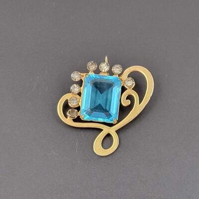 RHINESTONE & GOLD TONED BROOCH W/ BLUE GEM
