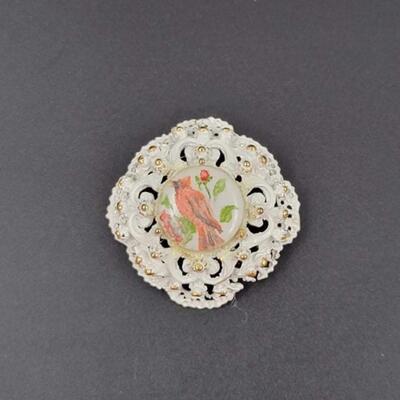 WHITE & GOLD METAL BROOCH W/ CERAMIC CARDINAL CENTER