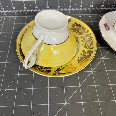 2 Tea Cups and Saucers: white with flowers and Yellow with Flowers