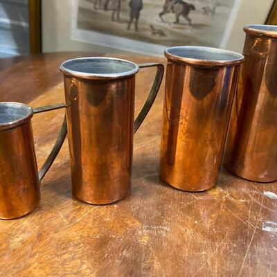 Set of four copper measuring shot/cups