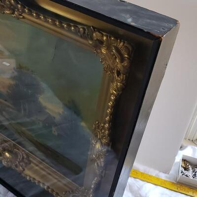 Original painting with ornate gold frame under glass