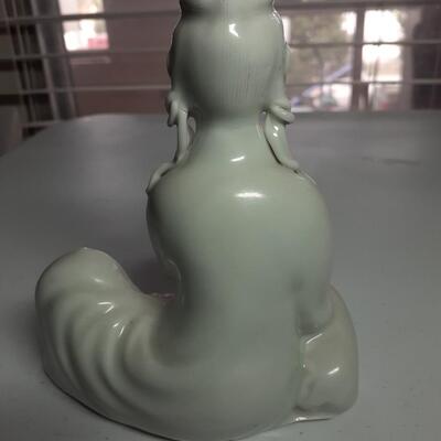 Girl with pig figurine