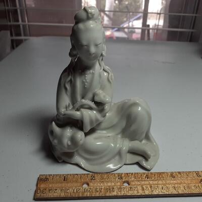 Girl with pig figurine