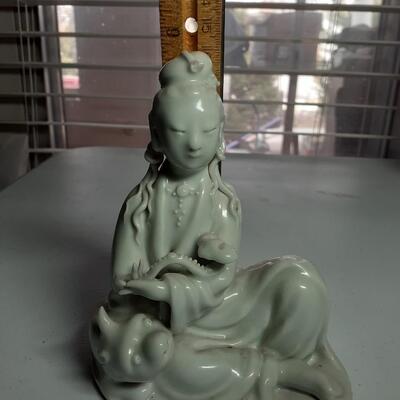 Girl with pig figurine