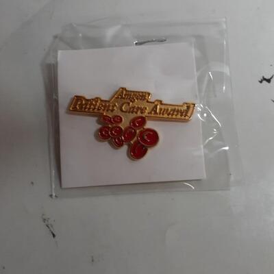 Lot of 12 China flag pins and 63 Amgen patient care award pins