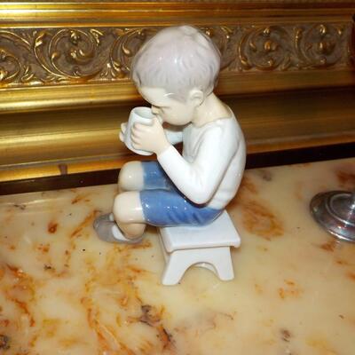 LLardro figurine of little boy.