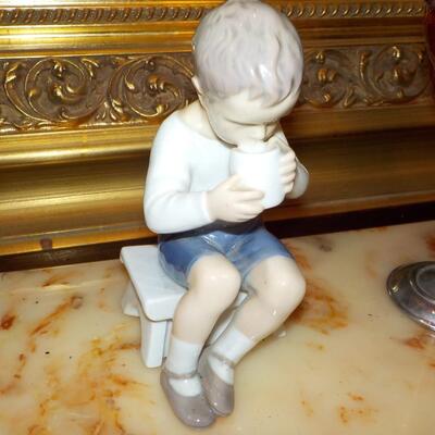 LLardro figurine of little boy.