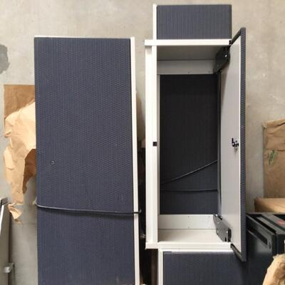 Cubicles under desk drawers and over desk storage cabinets with lights.