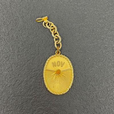 VINTAGE NOVEMBER GOLD TONED KEYCHAIN W/ GEM