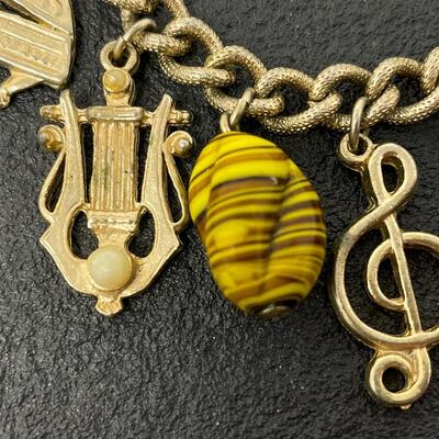 VINTAGE GOLD TONED CHARM BRACELET - MUSIC INSTRUMENTS & STONES