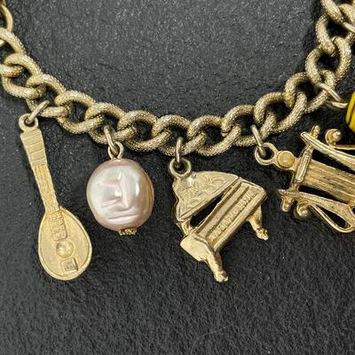VINTAGE GOLD TONED CHARM BRACELET - MUSIC INSTRUMENTS & STONES