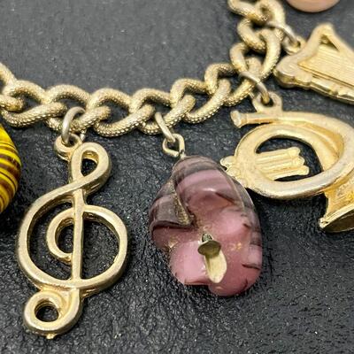 VINTAGE GOLD TONED CHARM BRACELET - MUSIC INSTRUMENTS & STONES