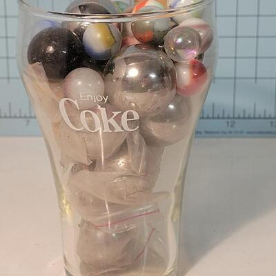 Marbles and steelies in Coca-Cola glass