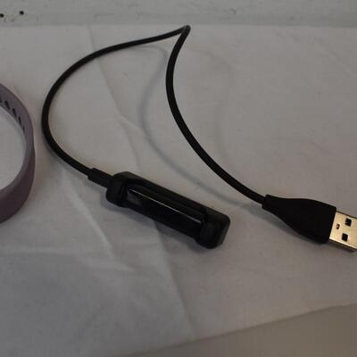 Fitbit With Charger and Two Purple Straps