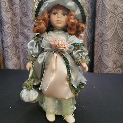 Red headed Porcelain doll on stand