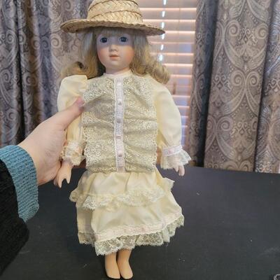 Beautiful porcelain Doll in yellow with sun hat