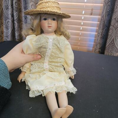 Beautiful porcelain Doll in yellow with sun hat