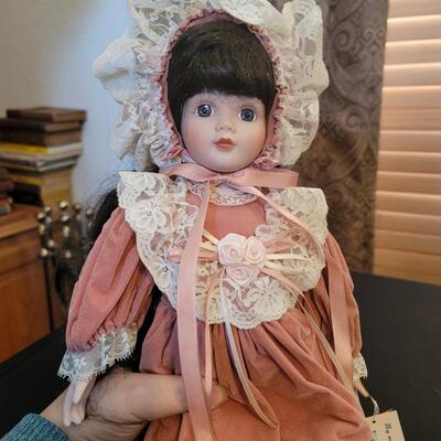 Brunette porcelain doll with bonnet