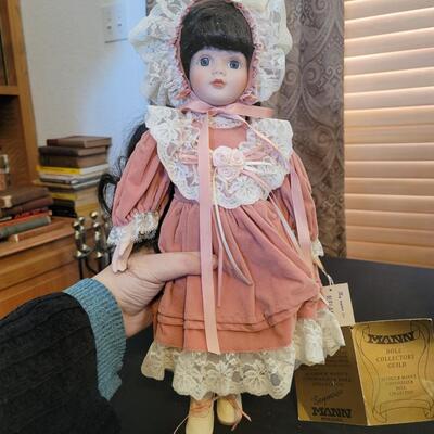 Brunette porcelain doll with bonnet