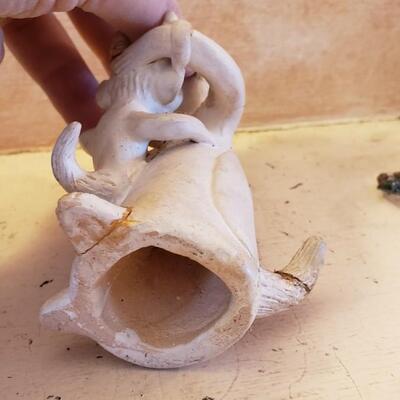Nursing horned figurine broken with repairs