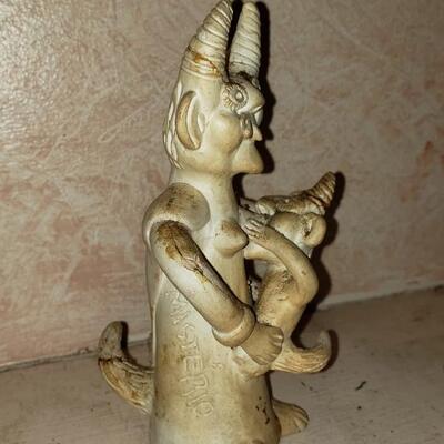 Nursing horned figurine broken with repairs