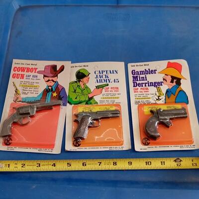 LOT 88 THREE VINTAGE CAP GUN KEY CHAINS | EstateSales.org