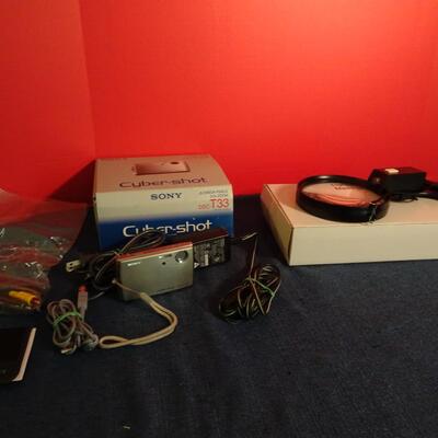 LOT 233. CYBER SHOT CAMERA AND MAGNIFYING GLASS