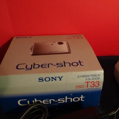 LOT 233. CYBER SHOT CAMERA AND MAGNIFYING GLASS
