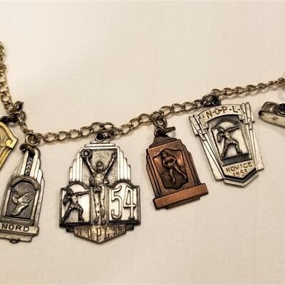 Lot #92  Bracelet with 7 vintage New Orleans Athletic Charms - 1950's