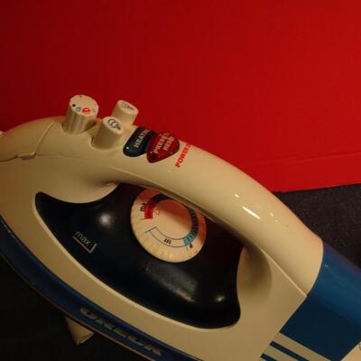 LOT 330. ORECK IRON AND STAND