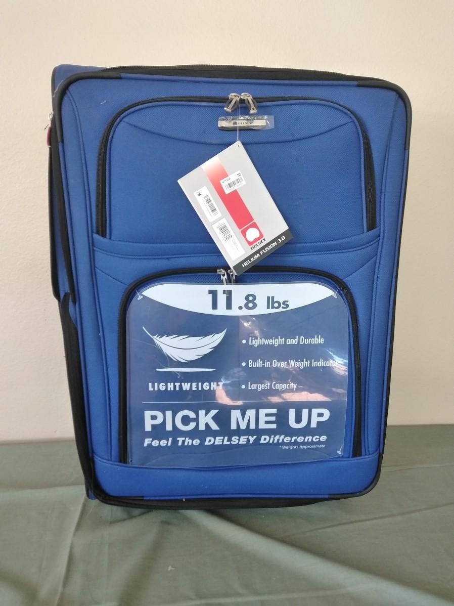 LOT 385 NEW DELSEY LIGHTWEIGHT SUITCASE WITH OVER WEIGHT INDICATOR