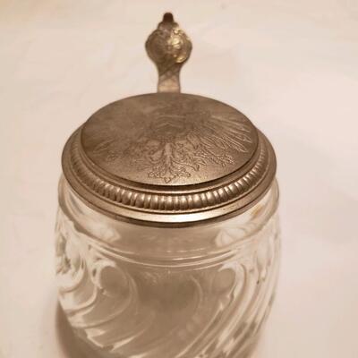 Glass jar with embossed flip metal lid