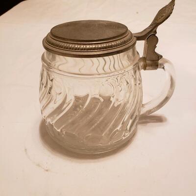 Glass jar with embossed flip metal lid