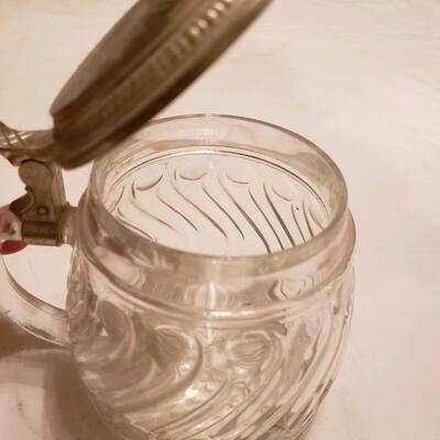 Glass jar with embossed flip metal lid