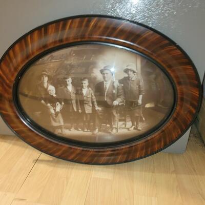 Antique photo with oval glass and wood frame real deal.
