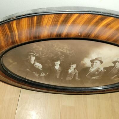 Antique photo with oval glass and wood frame real deal.